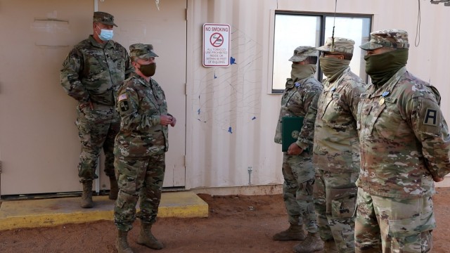 EL PASO, Texas – Lt. Col. Traci Earls, commander of the 169th Combat Sustainment Support Battalion, 69th Troop Command, Kansas Army National Guard, left, thanks Soldiers for their hard work and dedication to the mission at a small awards...
