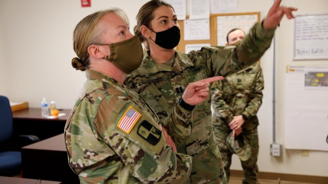 EL PASO, Texas – Lt. Col. Traci Earls, commander of the 169th Combat Sustainment Support Battalion, 69th Troop Command, Kansas Army National Guard, left, is briefed updates on the COVID-19 mitigation mission from Capt. Kelsie Knudson, West Bliss...