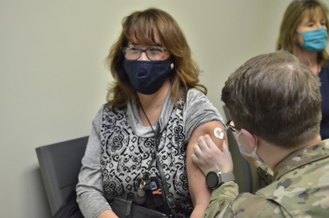 Erika Bowers, a third grade teacher at Andre Lucas Elementary, receives her second dose of Pfizer’s COVID-19 vaccine, Feb. 12, from Pvt. 1st Class Brianna Chamness, a medic assigned to Blanchfield Army Community Hospital, at BACH. “I’m just...