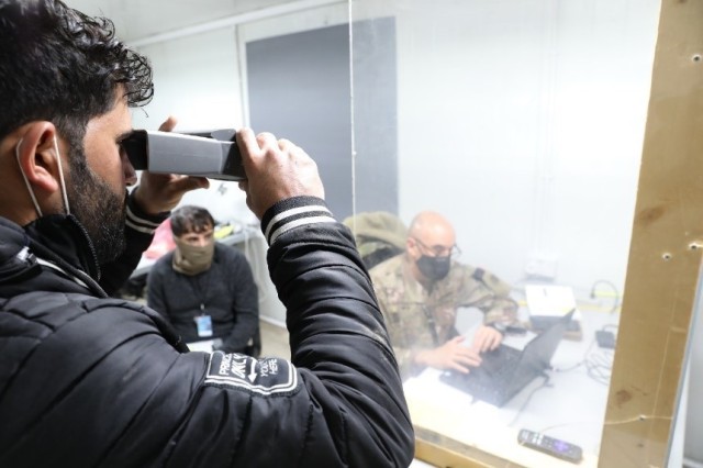 A truck driver undergoes an iris scan at Erbil Air Base, Iraq, Feb. 5, 2021 conducted by Chief Warrant Officer Lente, the officer in charge of the Syrian Logistics Cell military intelligence team or S-2. All drivers partake in the iris scan in addition to a fingerprint scan and a review of their record. (U.S. Army photo Capt. Elizabeth A. Rogers)