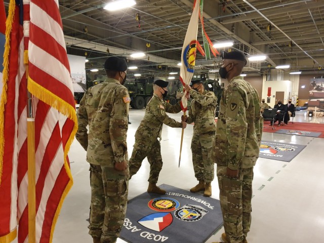 Command Sgt. Maj. John G. Ruiz, retiring command sergeant major of the 403rd AFSB, passes the brigade colors to Brigade Commander Col. Wheeler R. Manning, during the brigade’s change of responsibility ceremony at Camp Carroll, South Korea, Feb. 10. (Photo by Chu Myong-su, 403rd AFSB)