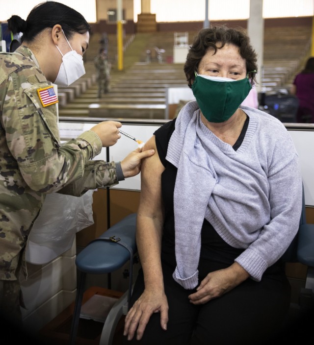 Members of the 402nd Army Field Support Brigade receive their first dose of the COVID-19 vaccine.