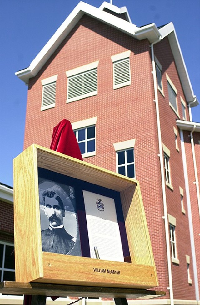 A shadowbox containing Sgt. Maj. William McBryar’s photo and brief biography sits near the wing of the Single Soldier Quarters named for him following its unveiling at the building’s dedication May 30, 2003. Photo by Prudence Siebert/Fort Leavenworth Lamp