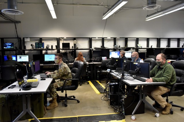 Major Matthew Gordon, left, directs testing of the fourth version of Live, Virtual, Constructive – Inte-grating Architecture, Feb. 9 at the Lt. Gen. Harry W.O. Kinnard II Mission Training Complex with staff from the complex and National Simulation Center of Fort Leavenworth, Kansas and Program Executive Office Simulation, Training and Instrumentation team from Orlando, Florida.