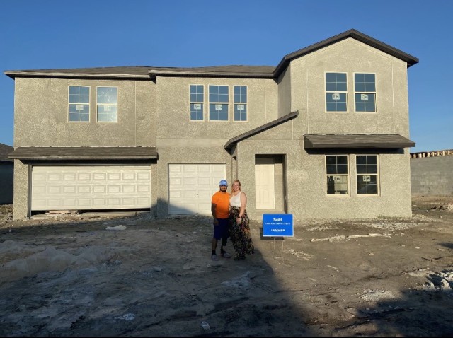 Spc. Zedrick Gonzalez and his wife Jennifer pose outside of their new home in Palmetto, Florida. (Photo by Spc. Zedrick Gonzalez)