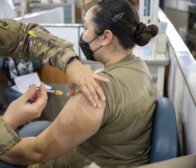 Members of the 402nd Army Field Support Brigade receive their first dose of the COVID-19 vaccine.