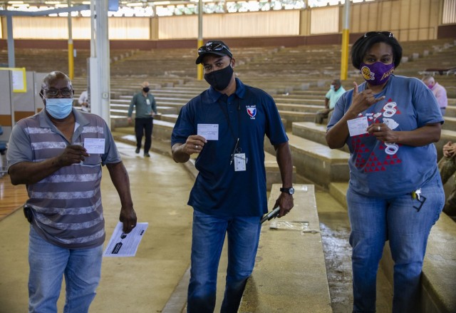 Members of the 402nd Army Field Support Brigade receive their first dose of the COVID-19 vaccine.