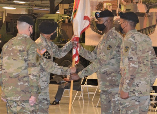 Col. Wheeler R. Manning, brigade commander, 403rd AFSB, passes the brigade colors to Command Sgt. Maj. Christopher J. Reaves, incoming brigade command sergeant major, during the brigade’s change of responsibility ceremony at Camp Carroll, South Korea, Feb. 10.