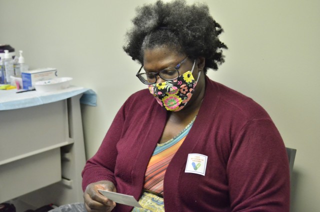 Shauna Graves, third grade teacher at Barsanti Elementary, takes a look at her vaccination card after receiving her second dose of Pfizer’s COVID-19 vaccine Feb. 12 at Blanchfield Army Community Hospital.