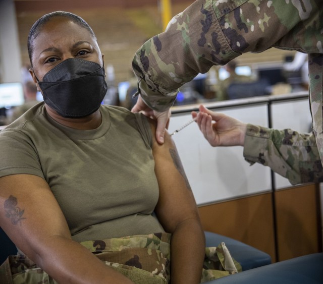 Members of the 402nd Army Field Support Brigade receive their first dose of the COVID-19 vaccine.