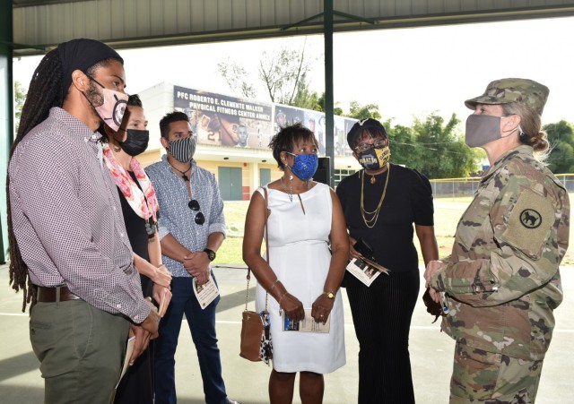 Maj. Gen. Jami C. Shawley, Commanding General of the 81st Readiness Division and Fort Buchanan's Senior Mission Commander speaks with Roberto Clemente's family prior to the memorialization ceremony of Fort Buchanan’s Physical Fitness Center...