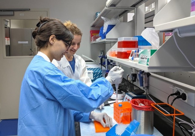 Dr. Maia Nozadze, (white coat) USAMRD-G Georgian Laboratory Associate, instructs intern Natia Inadze on the proper techniques required to extract nucleic acid from human specimens in order to perform complex  molecular testing in the search for the microbial “culprits” of infectious disease.