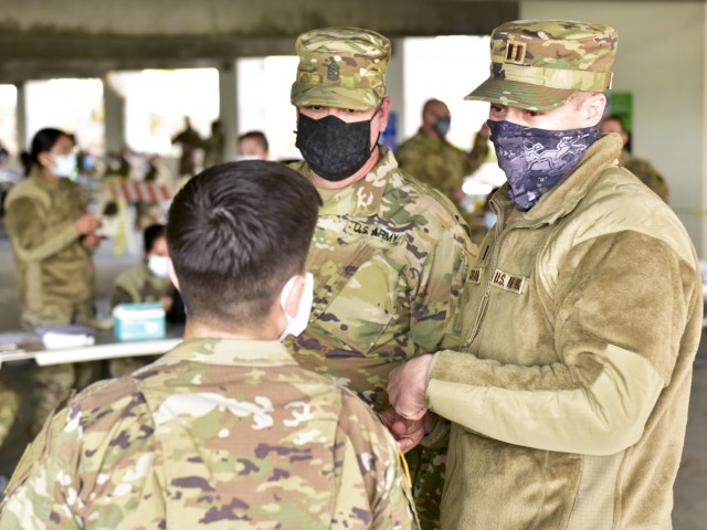 U.S. Air Force Capt. Scott Crandell, right, executive officer of Joint Task Force Mustang (JTFM), California National Guard, and U.S. Army Sgt. Maj. Robert Hammersley, senior enlisted advisor of JTFM, are briefed about operations at the walk-up...