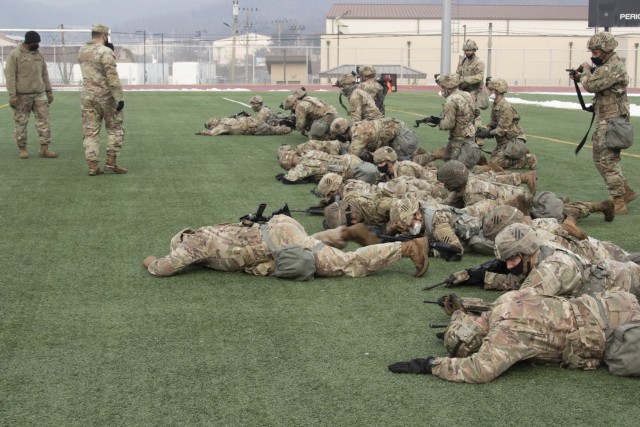 Soldiers assigned to 1st Armored Brigade Combat Team, 3rd Infantry Division low crawl with their weapons during the 2020 Warpaint Spur Ride, December 22-23, at Camp Casey/Hovey, Republic of Korea. The Spur Ride is a tradition in which Soldiers strive to earn spurs, an honorable award worn on their combat boots and a symbol of the ‘Order of the Spur,’ by completing rigorous challenges.  (U.S. Army photo by KPfc. Seong Min Choi, 1st Armored Brigade Combat Team, 3rd Infantry Division)