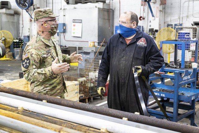  TACOM Chaplain Scott Koeman speaks with an employee in the Combat Vehicle Repair Facility during his visit to Anniston Army Depot. 