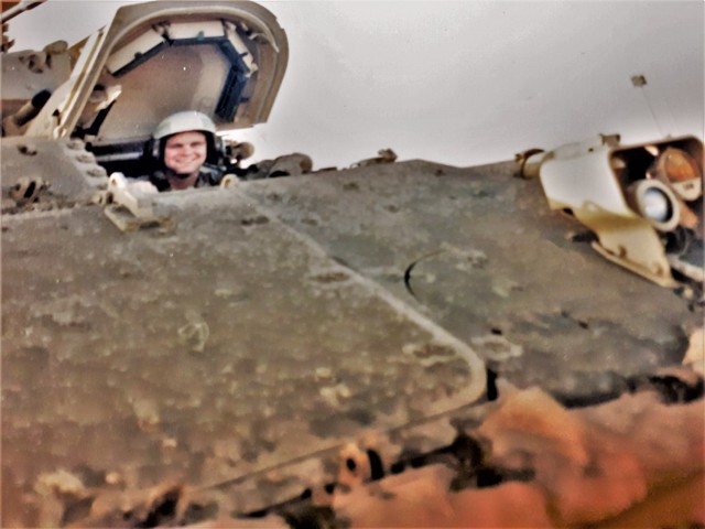 Army Spc. Arthur Saily II with the Army's Alpha Company, 1st Battalion, 5th Cavalry Division of Fort Hood, Texas, peers out the hatch of an M2 Bradley Infantry Fighting Vehicle on Feb. 23, 1991, near the Saudi Arabia/Iraq border. Saily was part of...