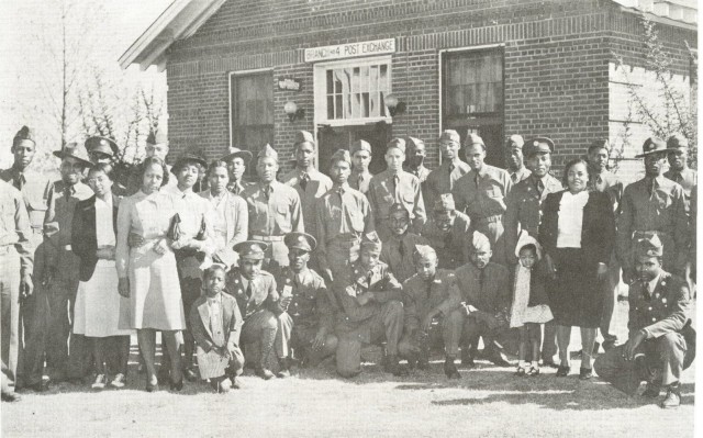 FORT BENNING, Ga. – Soldiers of the all-African American 24th Infantry Regiment and family members in 1941 outside the building here that housed the regiment's post exchange and snack bar. The building, which was across the street from the regiment's barracks, was built in 1937. Officials here will unveil a commemorative plaque at the site Feb. 24 during an observance of African American History Month, which will honor African American Soldiers who served at Fort Benning. The day is also scheduled to include a visit to the regiment's former theater, to the home once occupied by retired Gen. Colin L. Powell when he was a captain and major, and a renaming of a band hall in honor of the former 24th Infantry Regiment bandmaster, Chief Warrant Officer Robert B. Tresville Sr. Activated in 1869, the regiment served in the American West, and saw action on San Juan Hill during Spanish American War, and also served in Mexico, the Philippines, in World War II and the Korean War. It was stationed at Fort Benning from 1922 to April 1942.