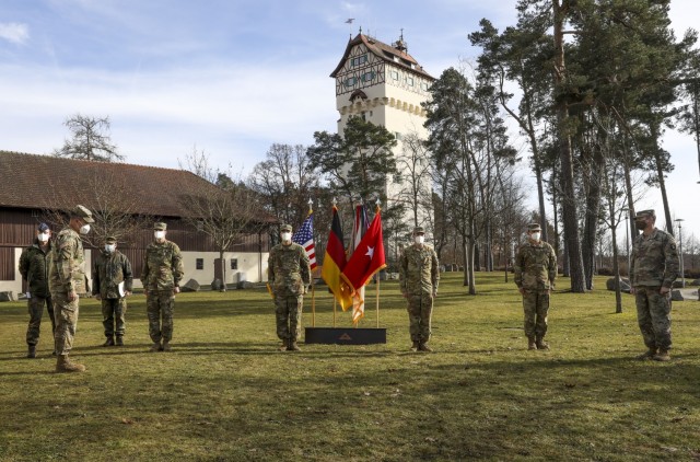 Brig. Gen. Christopher Norrie, Commander, 7th Army Training Command, addresses Maj. Benjamin Stork, Chief Warrant Officer 2 Robert Riedel, Sgt. Patrick Carter, and Spc. Bruce Cook, assigned to Bravo Company, 6th General Support Aviation Battalion, 101st Combat Aviation Brigade, during an awards ceremony recognizing the team for their efforts, Grafenwoehr, Germany, Feb. 18, 2021. Brig. Gen. Christopher Norrie and Brig. Gen. Thomas Hambach, Commander, Landeskommando Bayern, were both present at the award ceremony to thank the crew for their heroic actions.