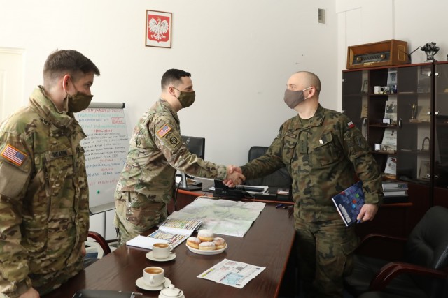U.S. Army Captain Zack Shearin, left, and  Major Donald Huskey, adjacent, 1st Squadron, 2d Cavalry Regiment, enhanced Forward Presence Battle Group Poland, meet with Polish Army leaders from 1st Battalion, 15th Mechanized Brigade, February 11, 2021, in Orzysz, Poland to discuss cooperation on exciting upcoming joint-training exercises.(U.S. Army photo by Staff Sgt. Elizabeth O. Bryson)(U.S. Army photo by Staff Sgt. Elizabeth O. Bryson)