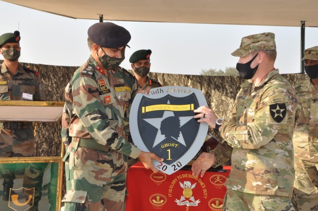Commanders from the Indian Army's 170th Infantry Brigade and the U.S. Army's 1-2 Stryker Brigade exchange gifts during Yudh Abhyas, Feb. 19, 2021 in India. Now in its 16th year, Yudh Abhyas builds on the enduring Indian-U.S. partnership through 14 days of combined field training, cultural exchange and a brigade-level command post exercise, leading to greater interoperability between the two nations, in support of a free and open Indo-Pacific. (Photo by Staff Sgt. Joe Tolliver, 1-2 Stryker Brigade Combat Team public affairs)