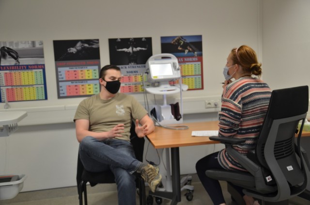 WIESBADEN, Germany—Staff Sgt. Geordyn Bryan with the 522nd Military Intelligence Battalion, is doing an intake interview with Autumn Feiring.  He came over to the AWC as a self-referral in order to improve his fitness level and increase his strength.