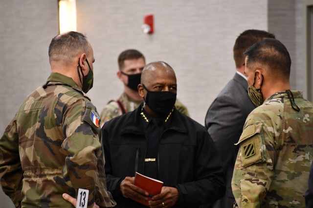 Brig. Gen. Hubert Cottereau (left), deputy commanding general, 3rd Infantry Division and Maj. Gen. Antonio Aguto (right), commanding general, 3rd ID, speak to Hinesville Chief of Police Lloyd Slater during the law enforcement symposium at Fort...