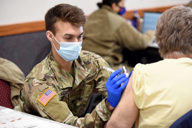 U.S. Army Spc. Lucas Tratechaud, a combat medic with 3rd Battalion, 126th Infantry Regiment, Headquarters and Headquarters Company, Michigan Army National Guard, vaccinates a resident in Coldwater, Michigan, Feb. 18, 2021. (U.S. Air National Guard photo by Master Sgt. David Eichaker)