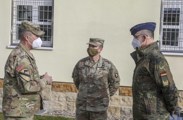 (From left to right) Brig. Gen. Christopher Norrie, Commander, 7th Army Training Command, Col. Travis Habhab, Commander, 101st Combat Aviation Brigade, and Brig. Gen. Thomas Hambach, Commander Landeskommando Bayern, speak following an award ceremony recognizing Habhab's Soldiers, Grafenwoehr, Germany, Feb. 18, 2021. Brig. Gen. Christopher Norrie and Brig. Gen. Thomas Hambach, were both present at the award ceremony to thank the crew for their heroic actions.