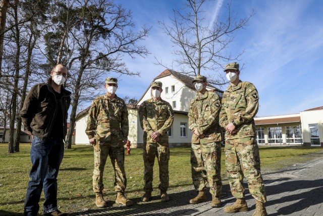 (From left to right) Joachim Strauch, a German who was treated by American Soldiers after being involved in a car crash, stands next to his rescuers; Maj. Benjamin Stork, Chief Warrant Officer 2 Robert Riedel, Sgt. Patrick Carter, and Spc. Bruce Cook, assigned to Bravo Company, 6th General Support Aviation Battalion, 101st Combat Aviation Brigade, during an awards ceremony recognizing the team for their efforts, Grafenwoehr, Germany, Feb. 18, 2021. Brig. Gen. Christopher Norrie, Commander, 7th Army Training Command, and Brig. Gen. Thomas Hambach, Commander, Landeskommando Bayern, were both present at the award ceremony to thank the crew for their heroic actions.