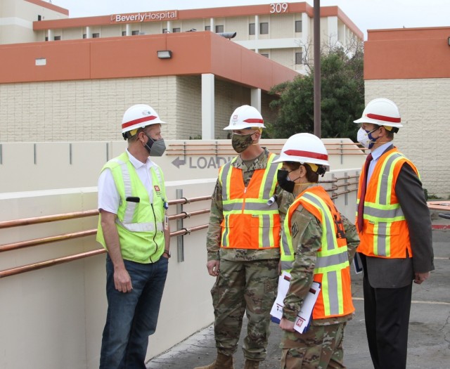 Martin Reed, contracting officer’s representative with the U.S. Army Corps of Engineers Rapid Response Technical Center of Expertise at the Omaha District, left, provides project updates to Brig. Gen. Paul Owen, U.S. Army Corps of Engineers South Pacific Division commander, center, during Owen’s Feb. 9, 2021 visit to Beverly Community Hospital in Montebello, California. Accompanying Owen were Col. Julie Balten, Los Angeles District commander, second from right, and David Van Dorpe, LA District deputy engineer.