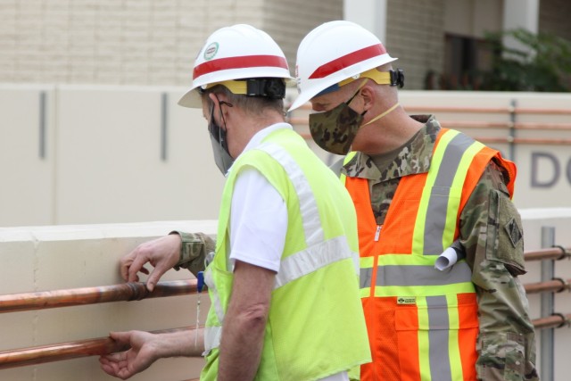 During his Feb. 9, 2020 visit to Beverly Community Hospital in Montebello, California, Brig. Gen. Paul Owen, U.S. Army Corps of Engineers South Pacific Division commander, right, joins Martin Reed, contracting officer’s representative with the U.S. Army Corps of Engineers Rapid Response Technical Center of Expertise at the Omaha District, to examine newly installed copper tubing designed to safely transport specialized medical-grade gas mixtures for hospital patients.