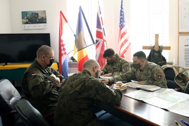 U.S. Army leaders from 1st Squadron, 2d Cavalry Regiment, enhanced Forward Presence Battle Group Poland, meet with Polish Army leaders from 1st Battalion, 15th Mechanized Brigade, February 11, 2021, in Orzysz, Poland to discuss cooperation on exciting upcoming joint-training exercises. (U.S. Army photo by Staff Sgt. Elizabeth O. Bryson)