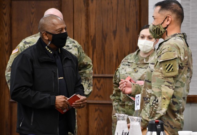 Maj. Gen. Antonio Aguto, commanding general, 3rd Infantry Division, speaks to Hinesville Chief of Police Lloyd Slater during the law enforcement symposium at Fort Stewart Feb. 18 2021. The symposium was a collaboration event with regional and...