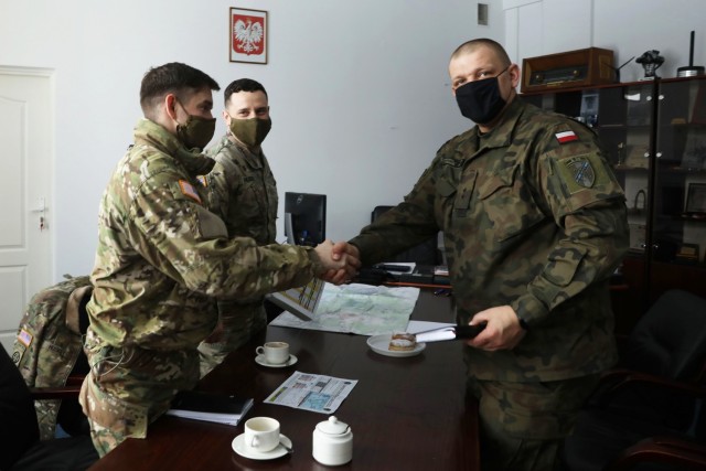 U.S. Army leaders from 1st Squadron, 2d Cavalry Regiment, enhanced Forward Presence Battle Group Poland, meet with Polish Army leaders from 1st Battalion, 15th Mechanized Brigade, February 11, 2021, in Orzysz, Poland to discuss cooperation on upcoming joint-training exercises. (U.S. Army photo by Staff Sgt. Elizabeth O. Bryson)