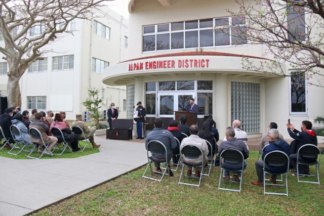 A crowd watches as Col. Thomas J. Verell, Jr., Japan Engineer District Commander, and Tsutomu Nakasone, an Okinawa Area Office project manager with the Project Management Branch, place items into a time capsule that will remain sealed until the...