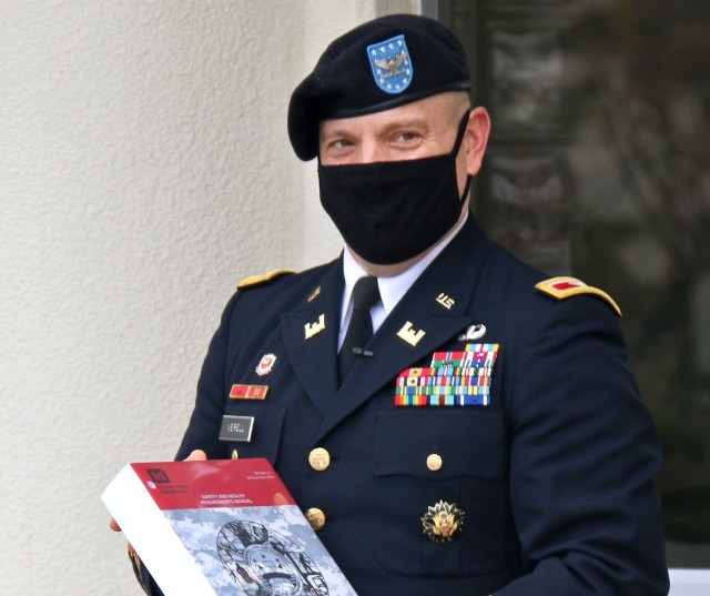 Col. Thomas J. Verell, Jr., 33rd Commander of the U.S. Army Corps of Engineers in Japan, shows a gathered crowd one of the many items placed in a time capsule that will be sealed until the 100th anniversary of USACE in Japan comes in 2046. This...