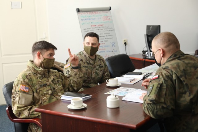 U.S. Army leaders from 1st Squadron, 2d Cavalry Regiment, enhanced Forward Presence Battle Group Poland, meet with Polish Army leaders from 1st Battalion, 15th Mechanized Brigade, February 11, 2021, in Orzysz, Poland to discuss cooperation on upcoming joint-training exercises. (U.S. Army photo by Staff Sgt. Elizabeth O. Bryson)