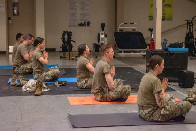 JOINT BASE LEWIS-MCCHORD, Wash.,-- Thunderbolt Soldiers use their lunch time to take advantage of a combat mobility yoga session Feb. 26, at 5th Battalion, 3rd Field Artillery Regiment headquarters. Yoga sessions are designed to improve overall mental wellness and increase core strength and mobility. (U.S. Army photo by Sgt. Casey Hustin, 17th Field Artillery Brigade)