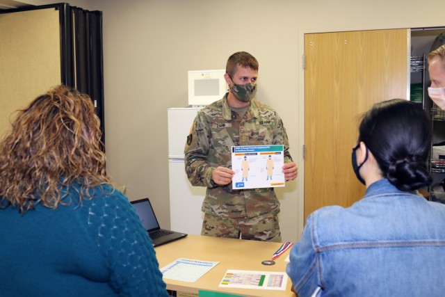 Maj. Kyle Zahn (center), the clinical nurse officer-in-charge of the Weed Army Community Hospital Medical Surgical Ward and Post-Anesthesia Care Unit (PACU), goes over COVID-19 protocols with participants of the hospital’s skills fair January 21...
