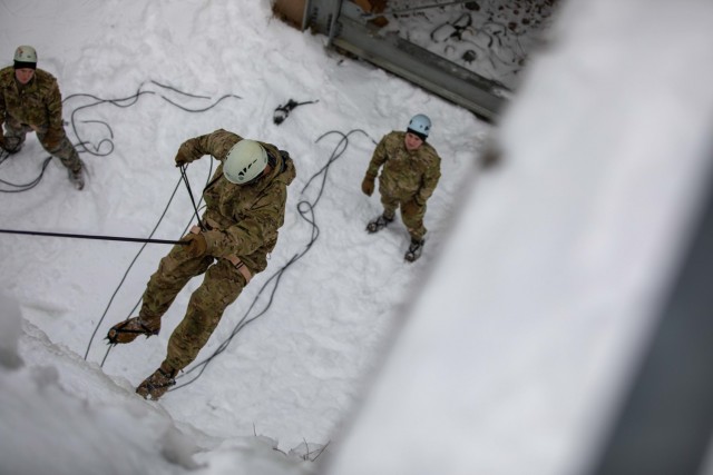 Capt. Robert Reed, an operations officer with Headquarters Support Company, Headquarters and Headquarters Battalion, 10th Mountain Division (LI) rappels down an ice wall at Camp Ethan Allen Training Site in Jericho, Vt., Feb. 19, 2021. Soldiers from the division were rewarded with the Mountain Legacy 2021 Training for  placing as one of the top three teams to complete the D-Series challenge at Fort Drum, N.Y. Feb. 9-10. (U.S. Army photo by Sgt. Elizabeth Rundell, 27th Public Affairs Detachment)