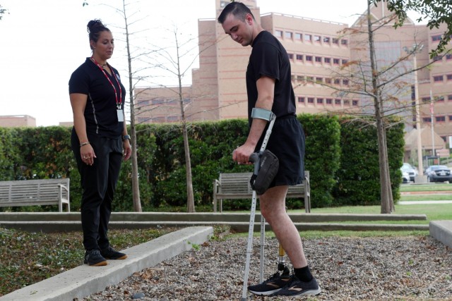 Candace Pellock, physical therapy assistant, guides Army Spc. Ezra Maes at the Center for the Intrepid, Brooke Army Medical Center’s rehabilitation center at Joint Base San Antonio-Fort Sam Houston, Texas, Oct. 2, 2019.