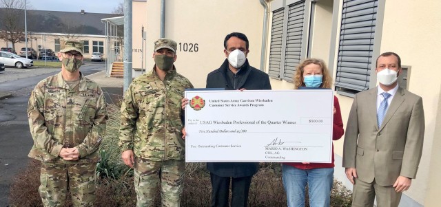Garrison Commander Col. Mario Washington, accompanied by Command Sgt. Maj. Christopher Truchon and Scott Mowry, deputy to the garrison commander, issue the $500 award and certificate of recognition to Directorate of Resource Management employees,...