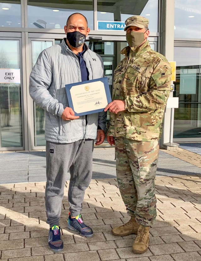 Garrison Commander Col. Mario Washington, issues the $500 award and certificate of recognition to Sascha Richardson, fitness center facilities manager, Feb. 19, 2021.