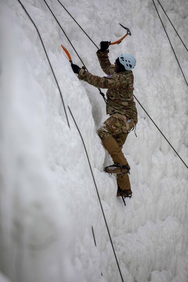 Capt. Johnathan Singleton, commander, Headquarters and Headquarters Troop, 1st Squadron, 89th Cavalry Regiment, 2nd Brigade Combat Team, 10th Mountain Division (LI), climbs the ice wall at Camp Ethan Allen Training Site in Jericho, Vt., Feb. 19, 2021. Singleton and a team of Soldiers from his unit placed first during the D-Series Competition on Fort Drum, N.Y., and earned the opportunity to learn mountain warfare tactics to include ice wall climbing, casualty evacuation through rough terrain and avalanche awareness training. (U.S. Army photo by Sgt. Elizabeth Rundell, 27th Public Affairs Detachment)