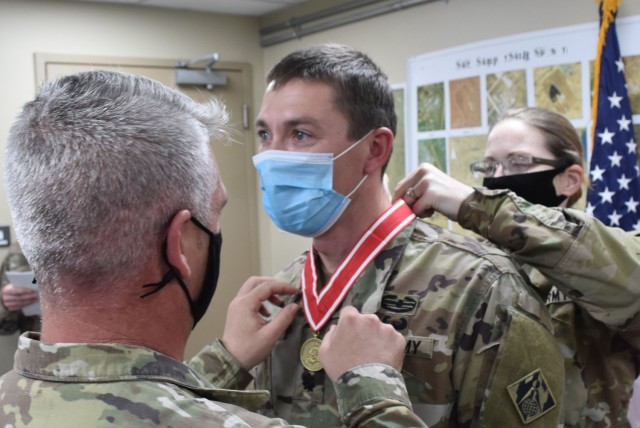 LTC Paul Sipe, outgoing Deputy Commander Afghanistan District is presented with the Bronze Order of the de Fleury Medal by Senior Enlisted Leader SGM Nathan Marshall and incoming Deputy Commander LTC Stephanie Radford in a ceremony held at...
