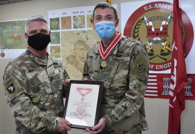 SGM Nathan Marshall and awardee LTC Paul Sipe display the Certificate accompanying the Bronze Order of the de Fleury Medal presented to Sipe February 2, 2021 at Task Force Essayons, Arifjan, Kuwait. (Photo by Rick Benoit)