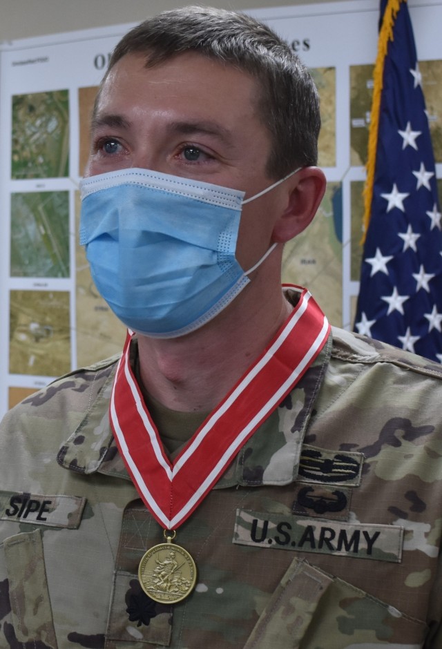 Lieutenant Commander Paul Sipe dons his recent award as he was presented the Bronze Order of the de Fleury Medal for his outstanding service for the Transatlantic Afghanistan District. (Photo by Rick Benoit)