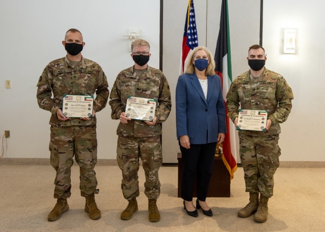Ambassador Alina L. Romanowski, United States ambassador to Kuwait, poses for a photo with 310th Expeditionary Sustainment Command Soldiers after an award ceremony recognizing them for their efforts in providing life-saving measures and assisting a local victim of a catastrophic vehicle accident in Kuwait City, Kuwait, Feb. 18, 2021. (U.S. Army Photo by Spc. Zoran Raduka, 1st TSC Public Affairs