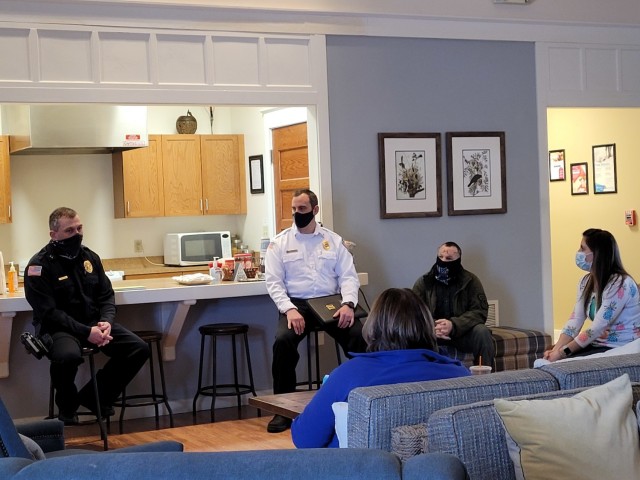 Fort Drum Deputy Chief of Operations Morgan Cady, Assistant Fire Chief Steve Larue and Lt. Rob Derouin, supervisory conservation law enforcement officer, answer questions from Mountain Community Homes residents during the Coffee with the Chiefs...