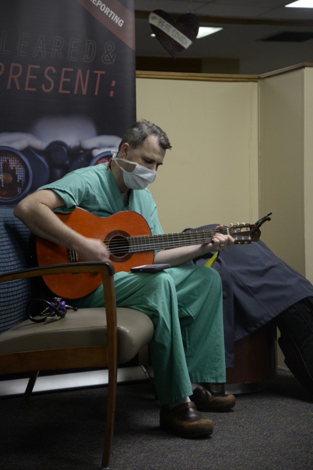 Maj. Douglas Westbrook, a nurse anesthetist at General Leonard Wood Army Community Hospital, plays his guitar in the hospital lobby for customers while off duty. Westbrook said his singing is for people who need calm while in a stressful place in their lives.